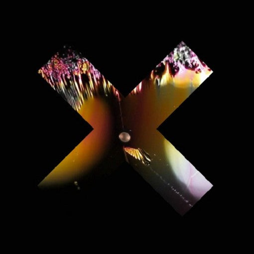 The xx Coexist CD jewel case front cover with minimalist monochrome photo and simple typography